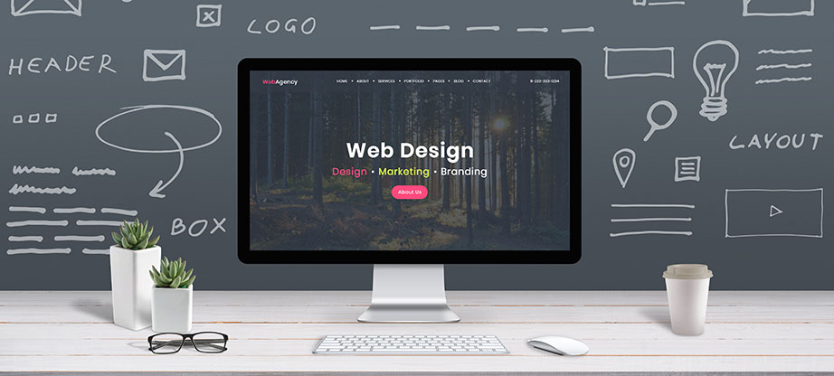 Web design concept with computer display, web theme and drawings of website, app parts. Modern design web page on computer display. Office, studio work desk.